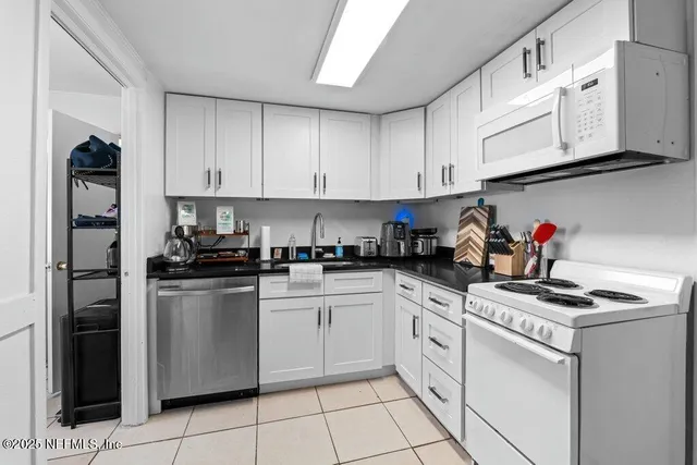 a utility room with cabinets dryer and washer