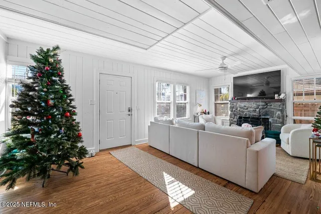 a bedroom with a bed a flat screen tv and a fireplace