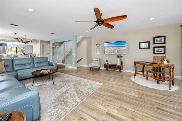 a living room with furniture and a wooden floor