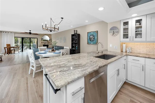 a kitchen with stainless steel appliances granite countertop a kitchen island a stove and a sink
