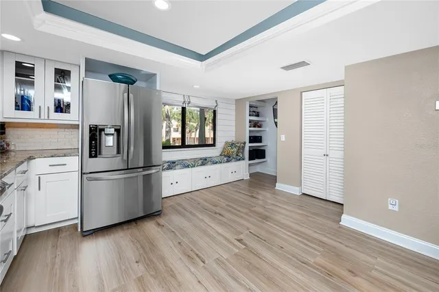 a kitchen with stainless steel appliances a refrigerator and wooden floor
