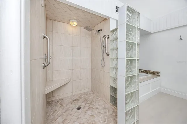 a en suite bathroom with a granite countertop sink and a mirror