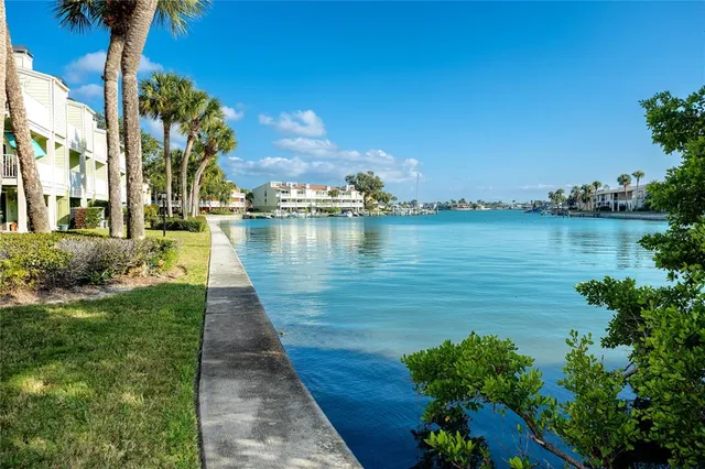 a patio with a table and chairs and potted plants