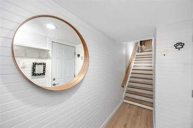 an view of a hallway with wooden floor and entryway