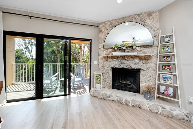 a living room with a fireplace and a floor to ceiling window