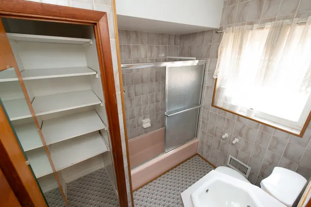 a bathroom with a toilet and a shower