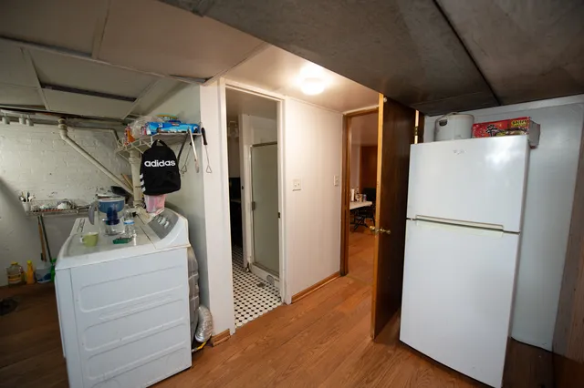 a view of a storage & utility room with closet wooden floor