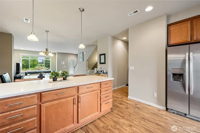 a large kitchen with kitchen island white cabinets and stainless steel appliances