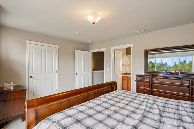 a room with a bed and a large window