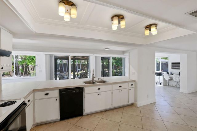 a large white kitchen with a window