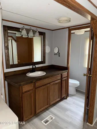 a bathroom with a double vanity sink mirror and toilet