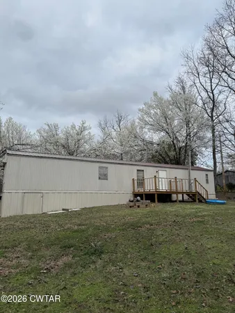 an outdoor view of house with yard and trees
