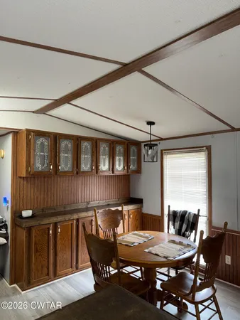 a dining room with furniture window and wooden floor