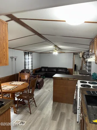 a kitchen with a sink a counter and chairs