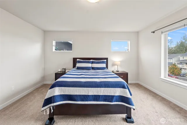 a bedroom with a bed and window