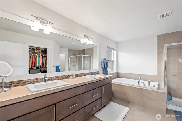 a bathroom with a sink double vanity granite and a mirror