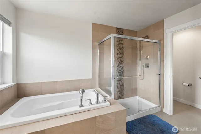 a bathroom with a bathtub and a shower