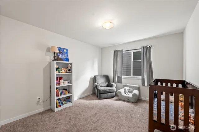 a livingroom with a book shelf and a window