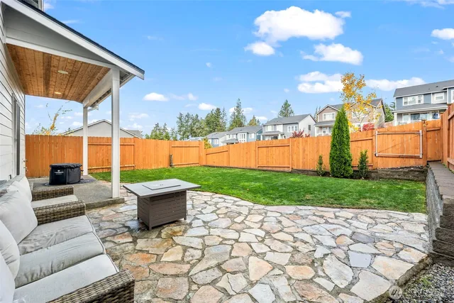 a view of a backyard with sitting area