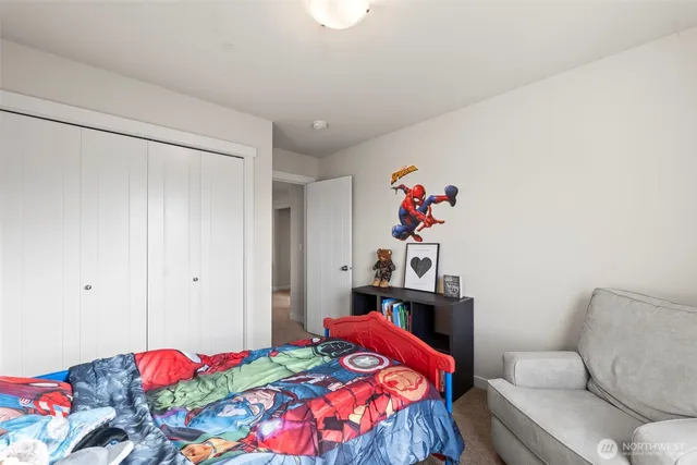 a bedroom with a bed and cabinets