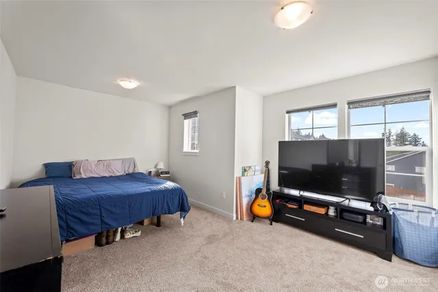 a living room with a flat screen tv and gym equipment