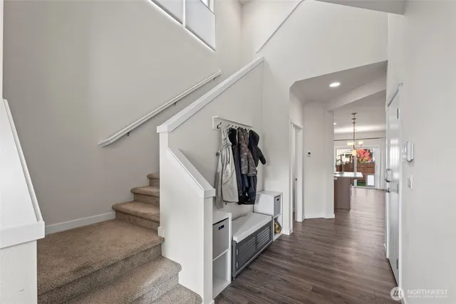 a view of a hallway view with living room and wooden floor