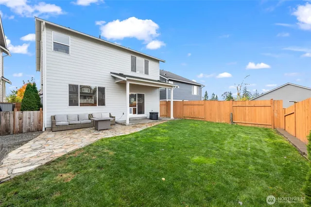 a front view of a house with a yard and outdoor seating