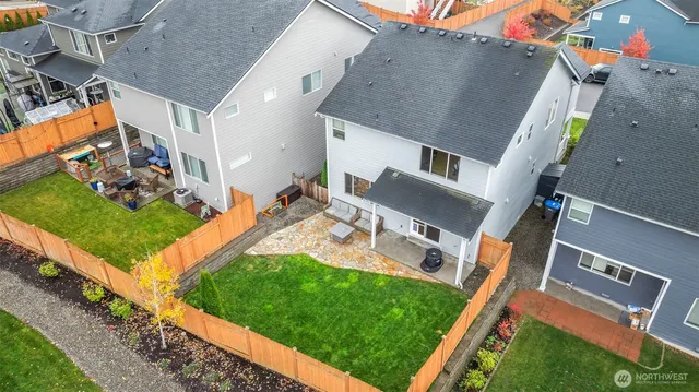 an aerial view of a house with a garden and deck