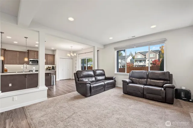 a living room with furniture and a kitchen
