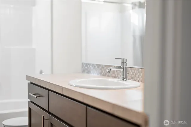 a bathroom with a sink and a mirror