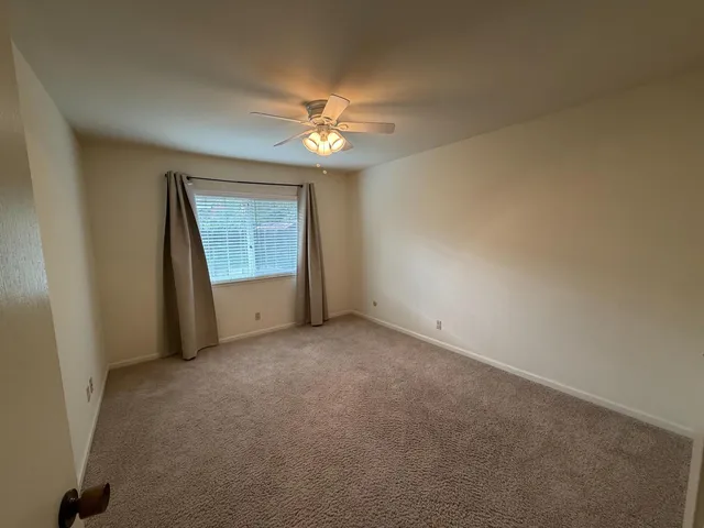 a bathroom with a granite countertop toilet sink and mirror
