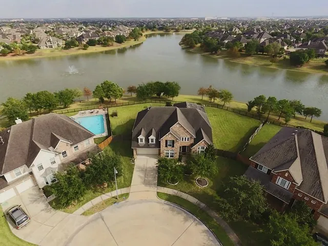 an aerial view of a house with a lake view