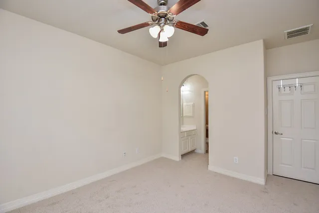 an empty room with closet and entryway