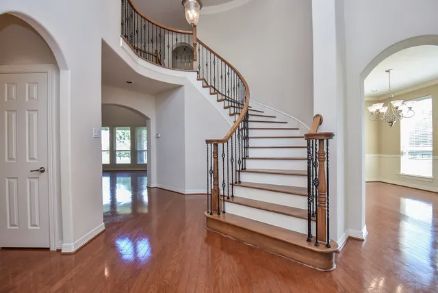a view of entryway and hall with wooden floor