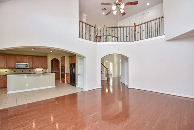 a view of living room and kitchen with wooden floor