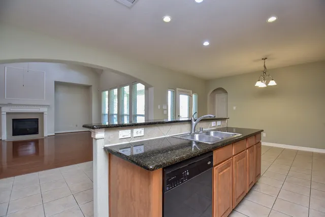 a kitchen with granite countertop a sink and stove