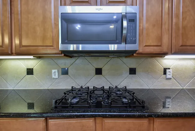 a kitchen with a stove and cabinets