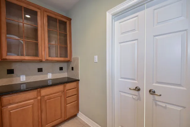 a kitchen with granite countertop cabinets and window
