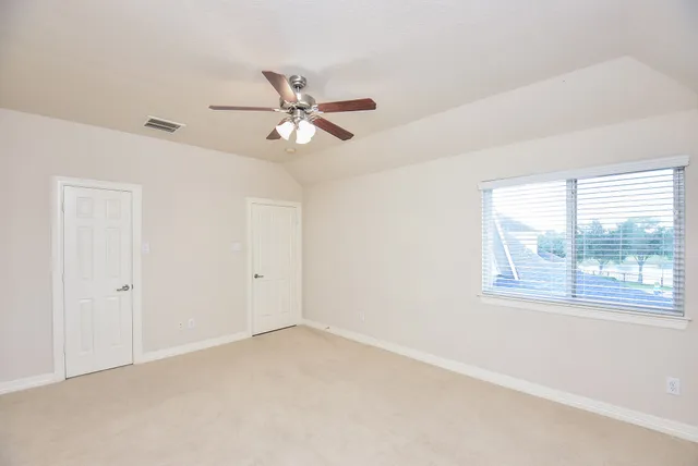a view of an empty room with a window
