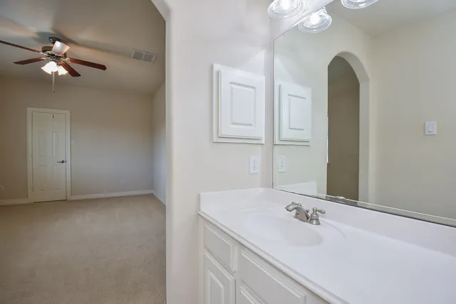 a bathroom with a double vanity sink and a mirror