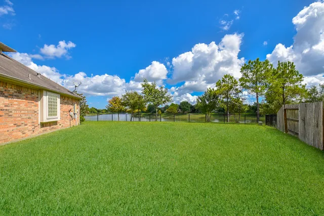 a front view of a house with lots of green space