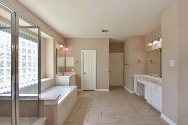 a bathroom with a glass door shower a sink and a mirror