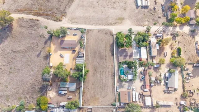 a aerial view of a house with a yard and large trees