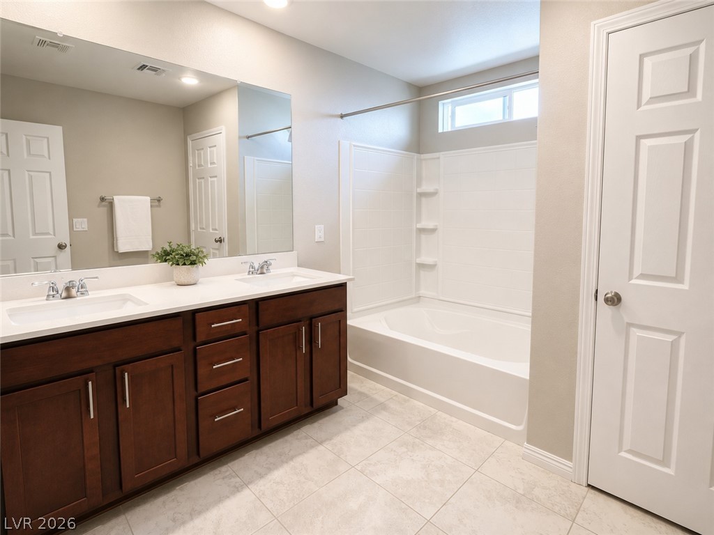 8768 Rio Andir Avenue Las Vegas, NV 89148 - Photo 6 of 9 Dual vanities and a clean, integrated tub and shower create a functional bathroom.