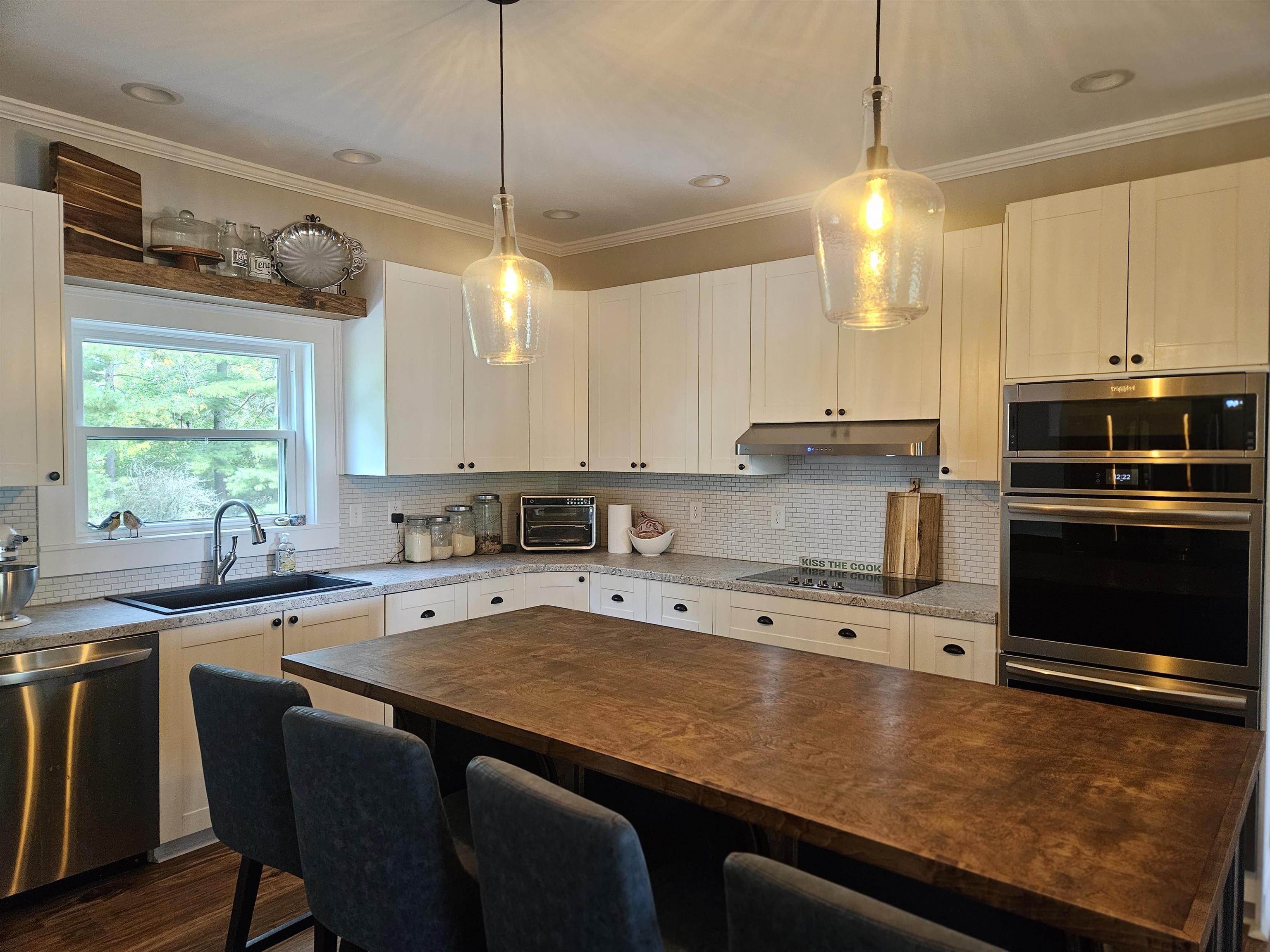 1851 West Winneshiek Road Freeport, IL 61032 - Photo 13 of 41 a kitchen with stainless steel appliances granite countertop a sink a stove and a refrigerator