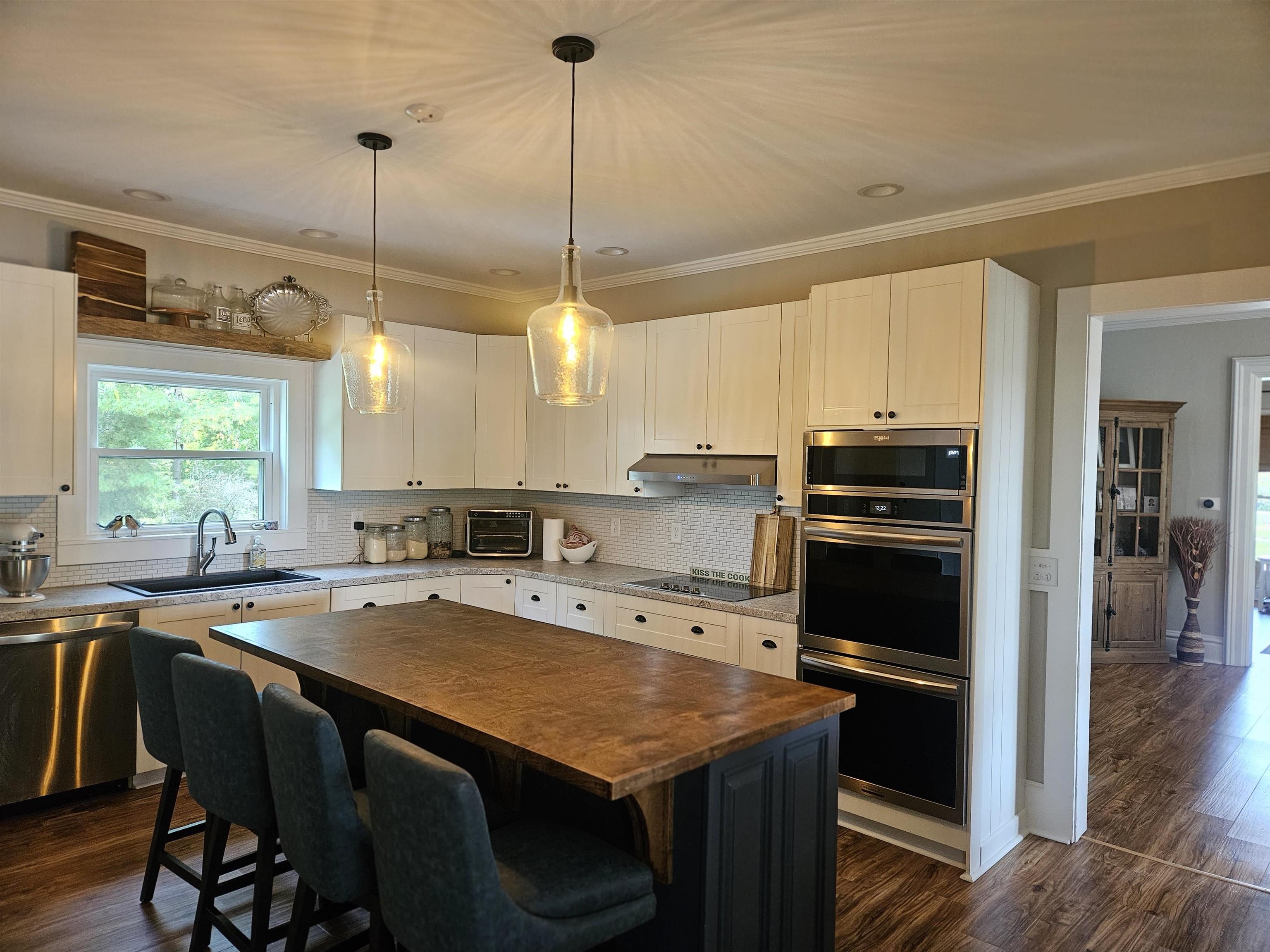 1851 West Winneshiek Road Freeport, IL 61032 - Photo 14 of 41 a kitchen with a sink a stove a refrigerator and chairs