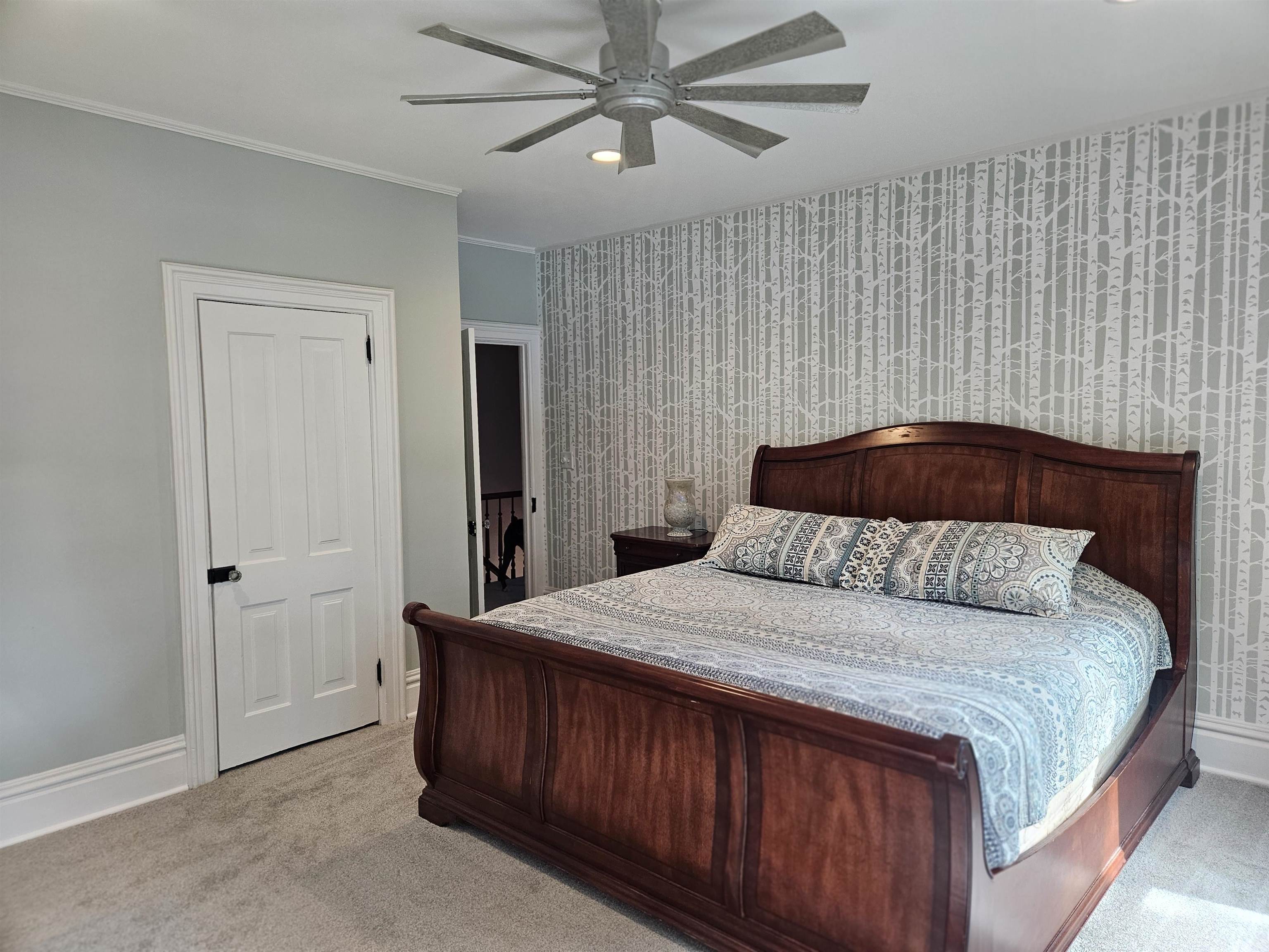 1851 West Winneshiek Road Freeport, IL 61032 - Photo 24 of 41 a bedroom with a large bed and a chandelier