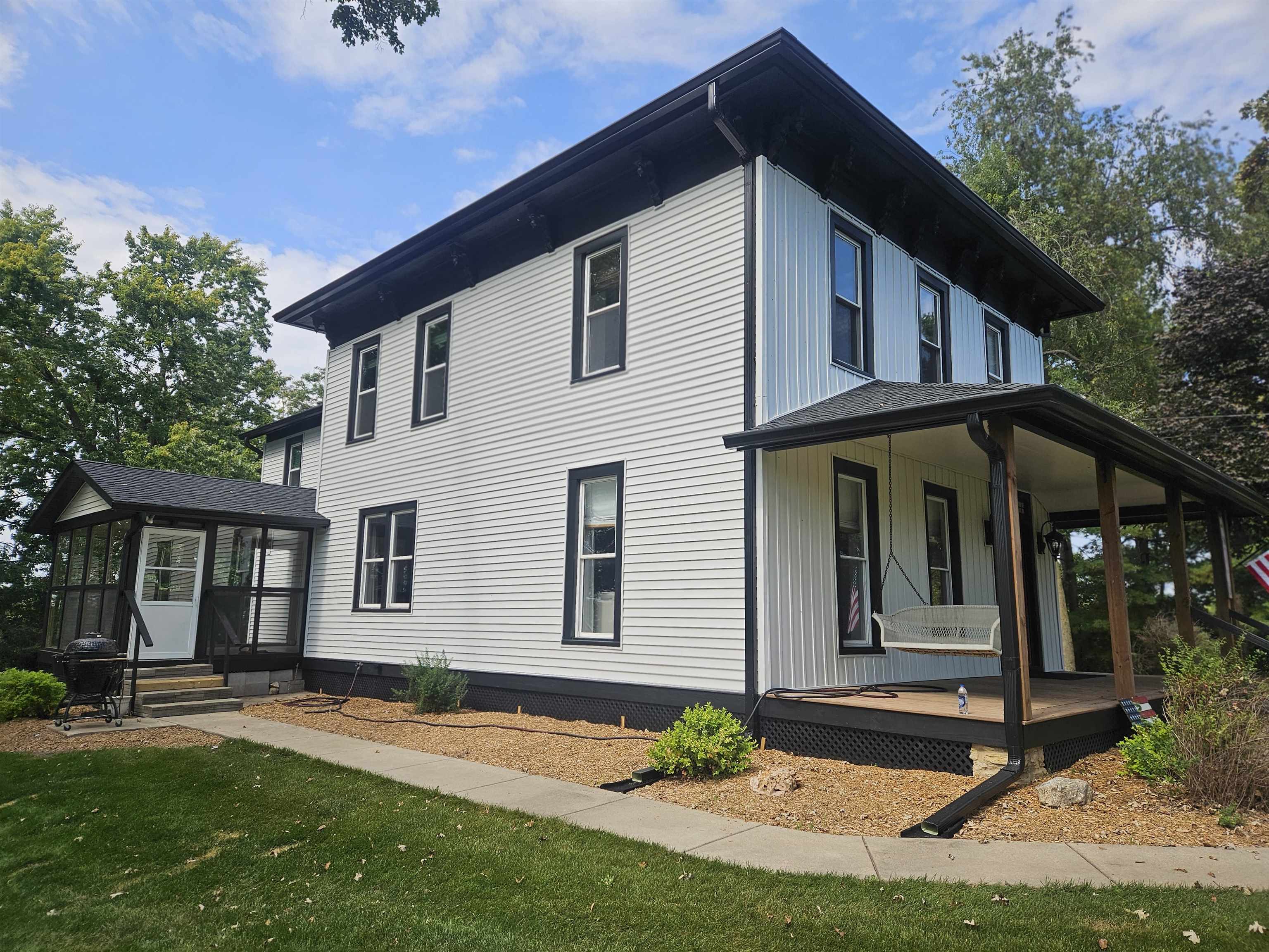 1851 West Winneshiek Road Freeport, IL 61032 - Photo 3 of 41 a view of a white house with a yard and plants