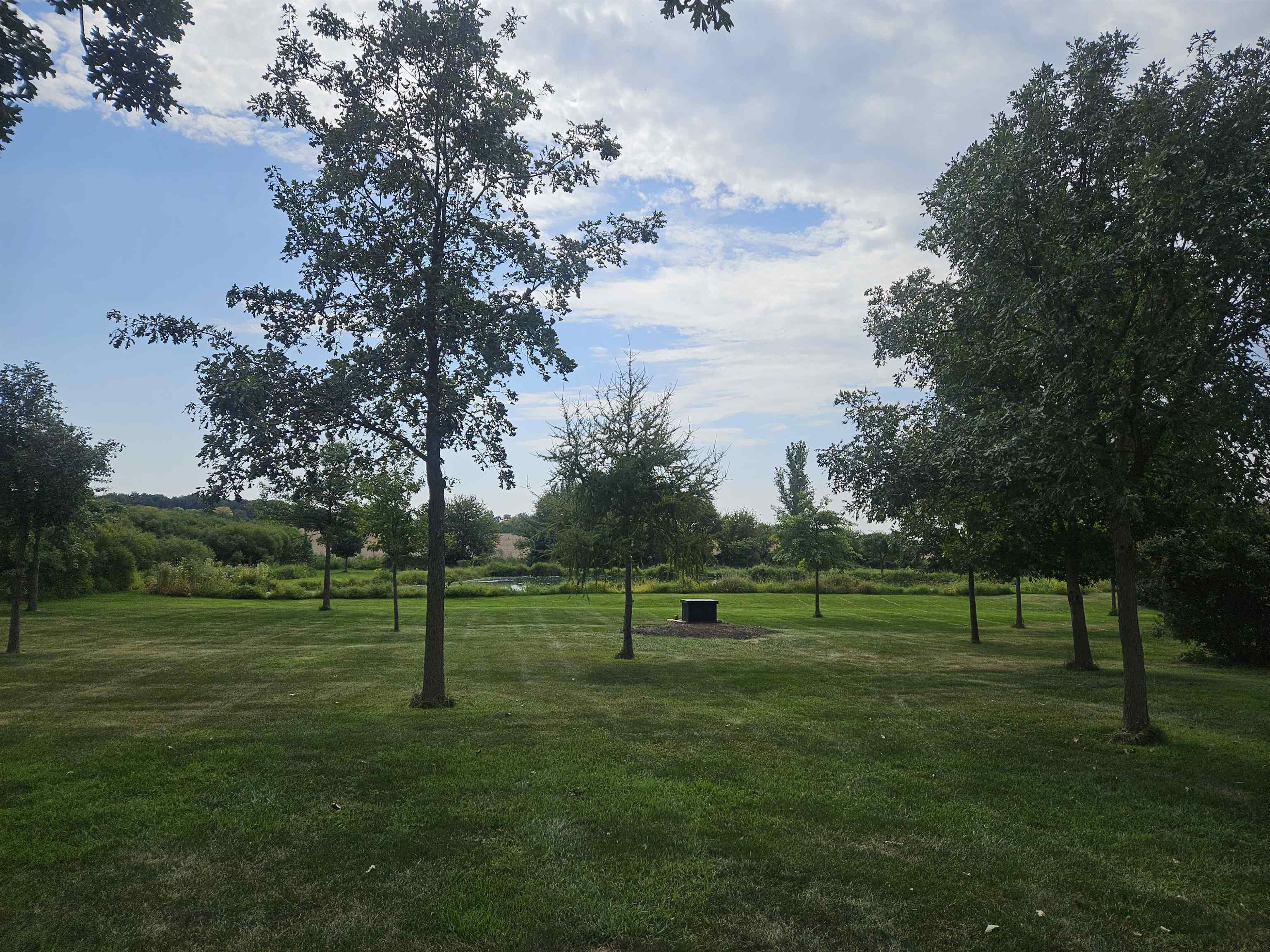 1851 West Winneshiek Road Freeport, IL 61032 - Photo 33 of 41 a green field with lots of trees in the background