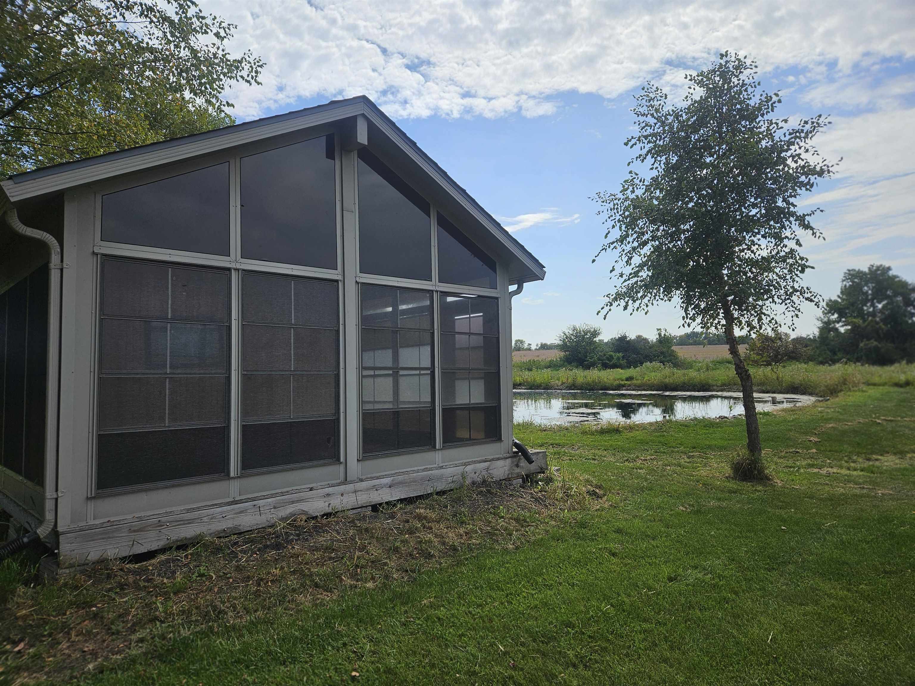 1851 West Winneshiek Road Freeport, IL 61032 - Photo 40 of 41 a backyard of a house with lots of green space and garden